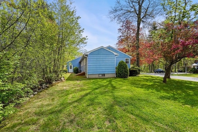 view of side of home featuring a yard