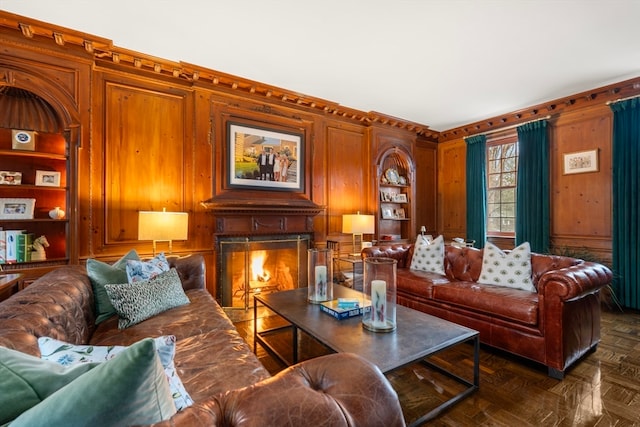 living room with dark parquet flooring and built in shelves