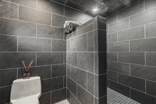 bathroom with tiled shower and toilet