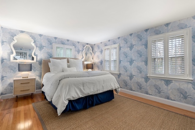 bedroom featuring hardwood / wood-style floors and multiple windows