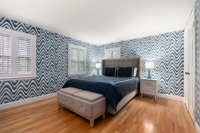 bedroom featuring wood-type flooring and multiple windows