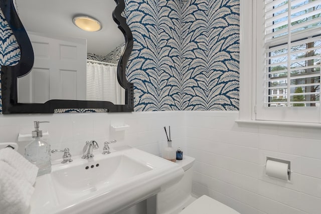 bathroom featuring tile walls and tasteful backsplash