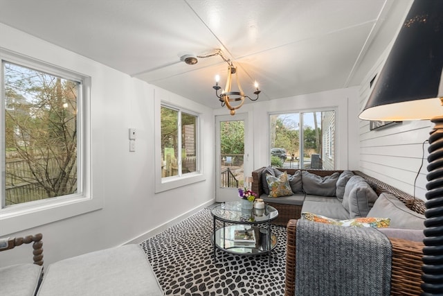 living room with a wealth of natural light and an inviting chandelier