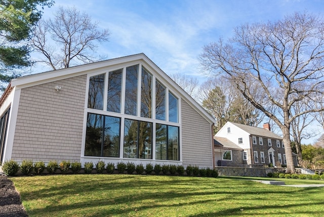 view of property exterior with a yard