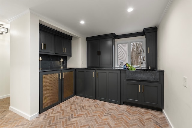 kitchen featuring tasteful backsplash, sink, and ornamental molding