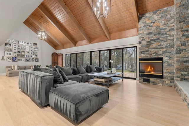 living room with wood ceiling, light hardwood / wood-style flooring, high vaulted ceiling, and a stone fireplace