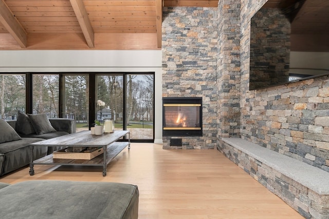 living room with a fireplace, hardwood / wood-style floors, beam ceiling, wooden ceiling, and a wealth of natural light