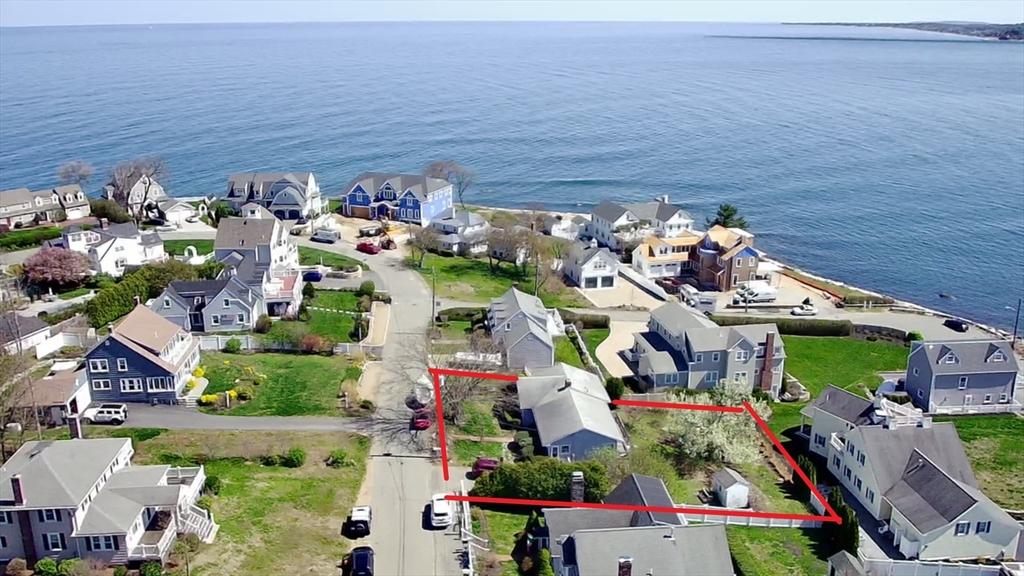 aerial perspective of suburban area featuring property boundaries highlighted and a nearby body of water