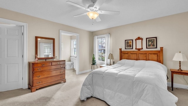 carpeted bedroom with connected bathroom and ceiling fan