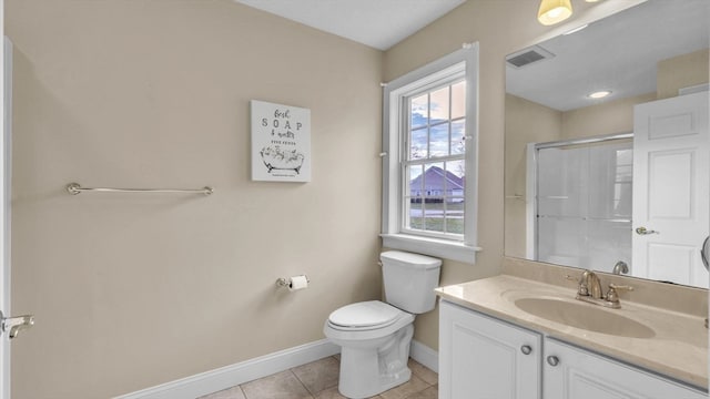 bathroom featuring walk in shower, vanity, toilet, and tile patterned flooring