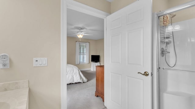 bathroom featuring an enclosed shower, vanity, and ceiling fan