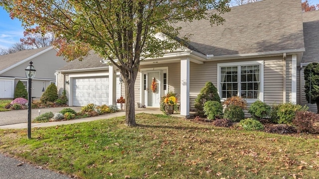 new england style home featuring a front lawn and a garage