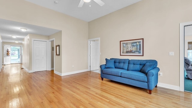 living room featuring ceiling fan and light hardwood / wood-style flooring