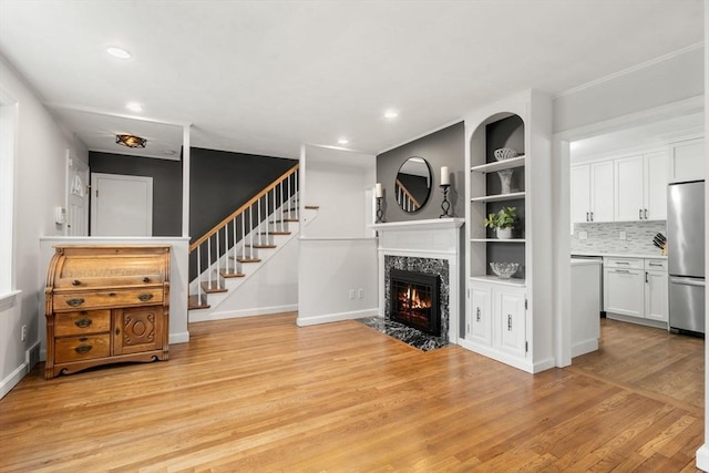37 Benjamin, Marlborough, MA 01752 - unfurnished living room featuring a high end fireplace, light wood finished floors, recessed lighting, stairs, and baseboards
