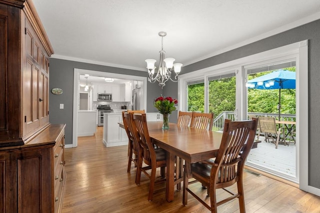 37 Benjamin, Marlborough, MA 01752 - dining room featuring light wood finished floors, a chandelier, crown molding, and baseboards