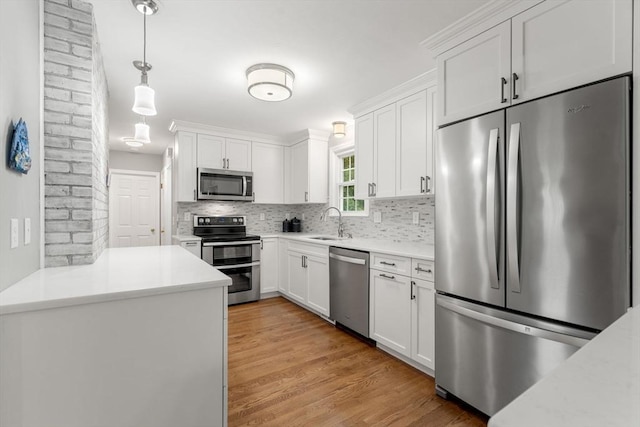 37 Benjamin, Marlborough, MA 01752 - kitchen featuring stainless steel appliances, a sink, decorative backsplash, and white cabinets