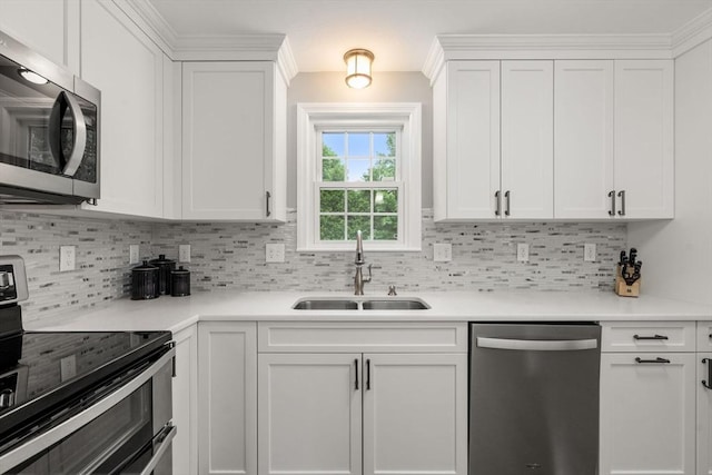 37 Benjamin, Marlborough, MA 01752 - kitchen featuring appliances with stainless steel finishes, a sink, white cabinets, tasteful backsplash, and light countertops