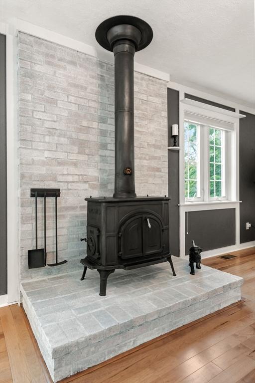 37 Benjamin, Marlborough, MA 01752 - detailed view of a wood stove, wood finished floors, and baseboards