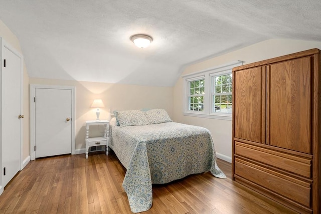 37 Benjamin, Marlborough, MA 01752 - bedroom featuring lofted ceiling, hardwood / wood-style flooring, a textured ceiling, and baseboards