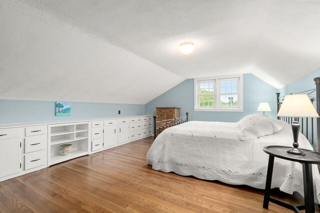 37 Benjamin, Marlborough, MA 01752 - bedroom featuring wood finished floors, vaulted ceiling, and a textured ceiling