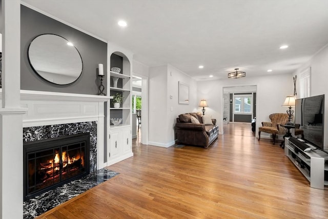 37 Benjamin, Marlborough, MA 01752 - living area with light wood finished floors, a high end fireplace, built in shelves, recessed lighting, and baseboards