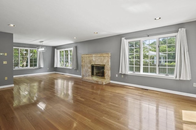 2-4 Founders Rd, Shrewsbury, MA 01545 - unfurnished living room with wood finished floors, a premium fireplace, and recessed lighting