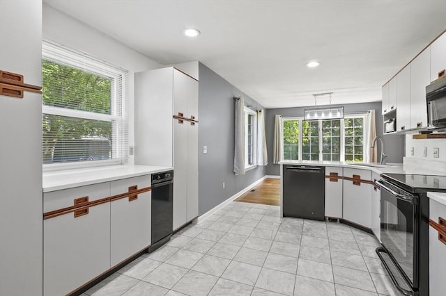 2-4 Founders Rd, Shrewsbury, MA 01545 - kitchen with black appliances, light countertops, plenty of natural light, light tile patterned flooring, and recessed lighting