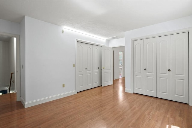 2-4 Founders Rd, Shrewsbury, MA 01545 - unfurnished bedroom with multiple closets and light wood-style flooring