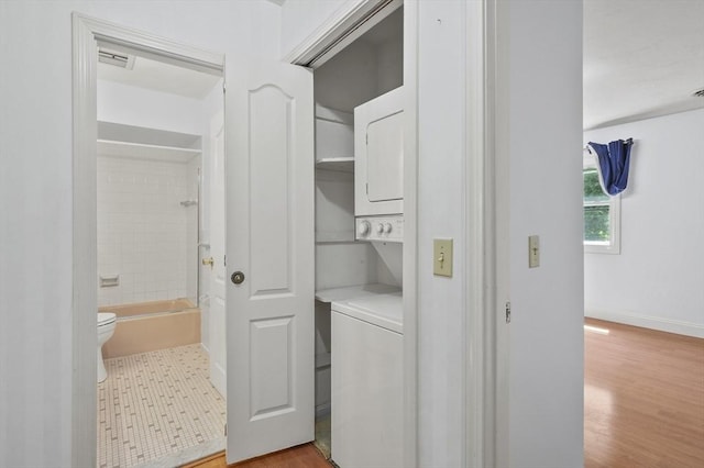 2-4 Founders Rd, Shrewsbury, MA 01545 - laundry room with stacked washer / dryer and light wood-style floors