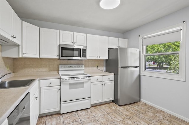 2-4 Founders Rd, Shrewsbury, MA 01545 - kitchen featuring appliances with stainless steel finishes, white cabinets, backsplash, and light countertops