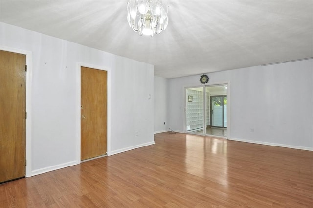2-4 Founders Rd, Shrewsbury, MA 01545 - unfurnished living room with a chandelier and wood finished floors