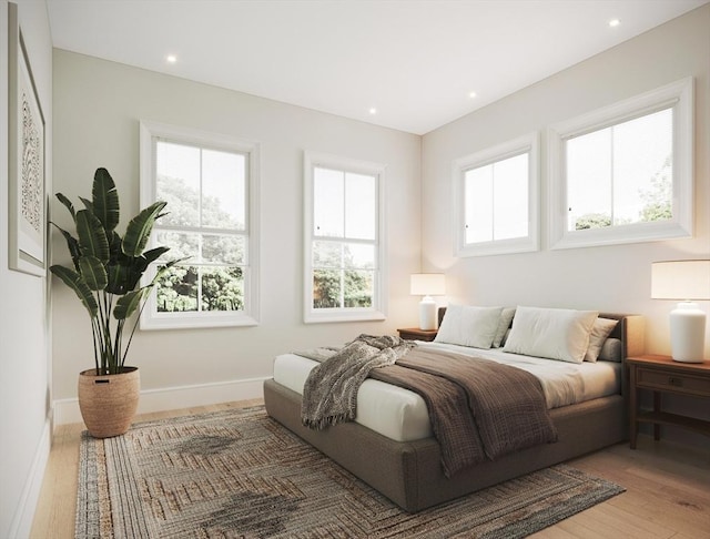 bedroom featuring wood-type flooring and multiple windows