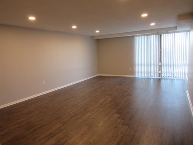 empty room with dark hardwood / wood-style floors