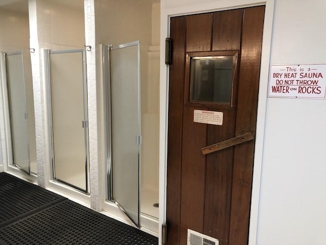 bathroom featuring a shower with shower door