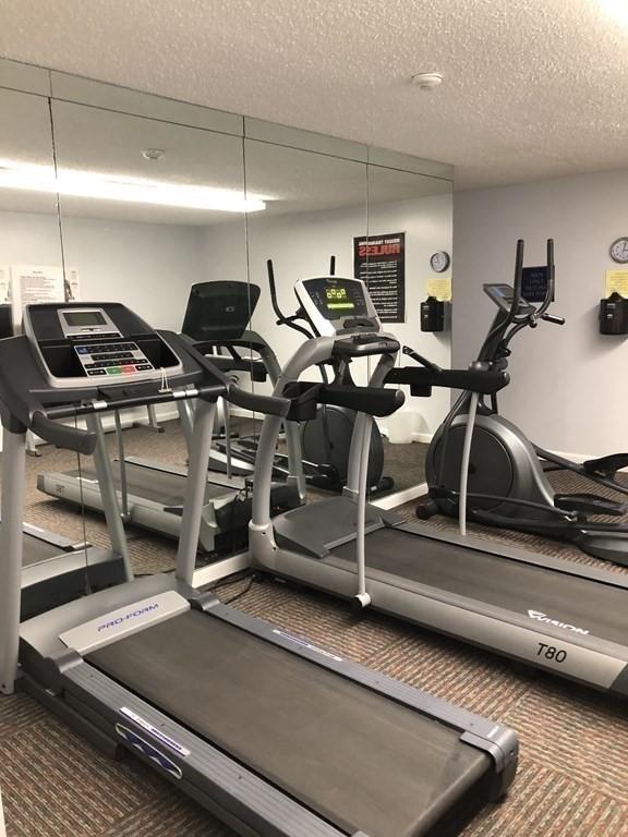 workout area with a textured ceiling