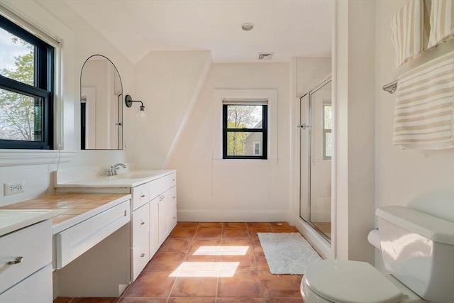 full bath featuring vanity, tile patterned floors, a stall shower, and toilet