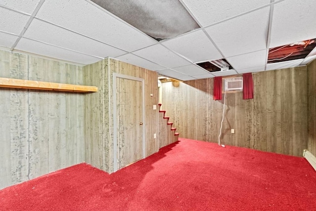 178 Elliot Ave, Quincy, MA 02171 - finished basement with a drop ceiling, wooden walls, carpet, stairs, and a wall mounted AC