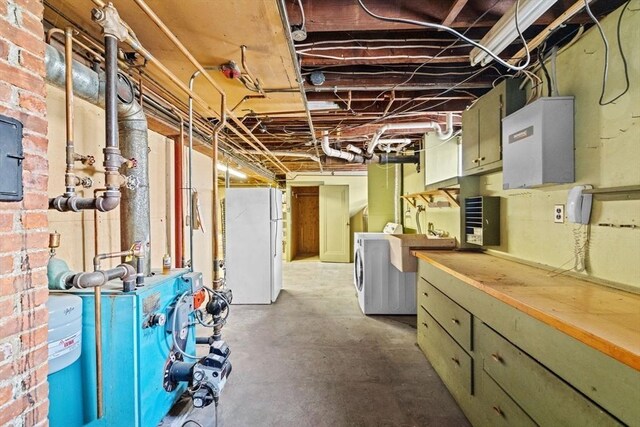 178 Elliot Ave, Quincy, MA 02171 - unfinished below grade area with freestanding refrigerator, a heating unit, and washer and clothes dryer