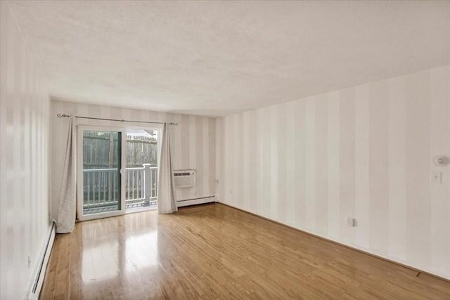 205 Independence Ave Unit 223, Quincy, MA 02169 - unfurnished room featuring wallpapered walls, a baseboard radiator, baseboard heating, wood finished floors, and a wall mounted AC