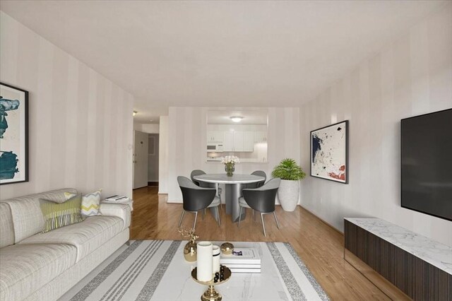 205 Independence Ave Unit 223, Quincy, MA 02169 - living area with wallpapered walls and light wood-style flooring