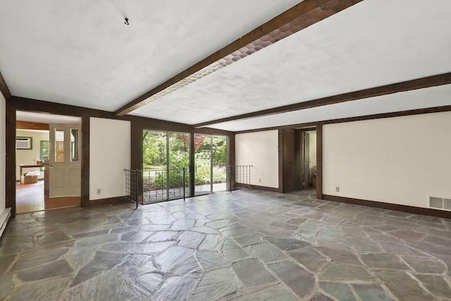 155 Glen Charlie Rd, Wareham, MA 02538 - spare room with stone floors, beamed ceiling, healthy amount of natural light, and an AC wall unit