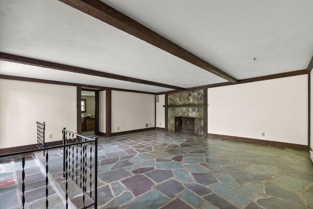 155 Glen Charlie Rd, Wareham, MA 02538 - unfurnished living room with stone flooring, beam ceiling, and a stone fireplace