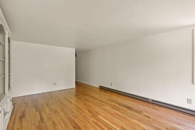 155 Glen Charlie Rd, Wareham, MA 02538 - empty room featuring a baseboard heating unit and light wood-style flooring