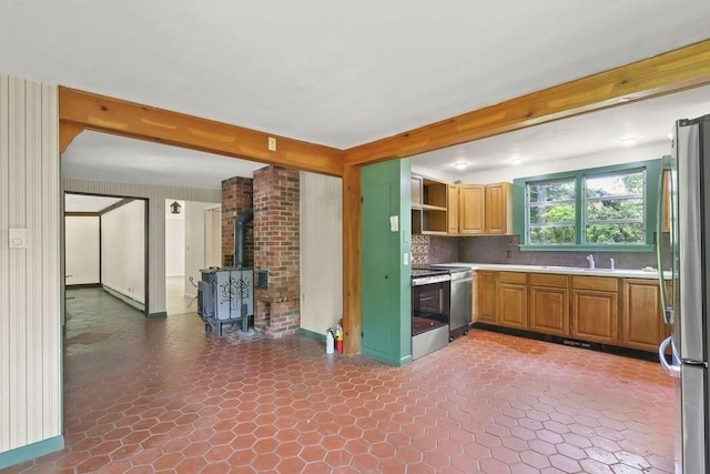 155 Glen Charlie Rd, Wareham, MA 02538 - kitchen with appliances with stainless steel finishes, a wood stove, open shelves, light countertops, and beamed ceiling