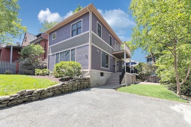 view of front of home featuring a balcony and stairs