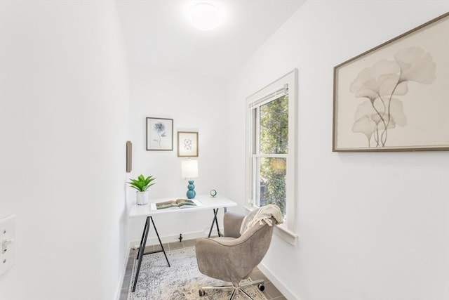 office area with baseboards and wood finished floors