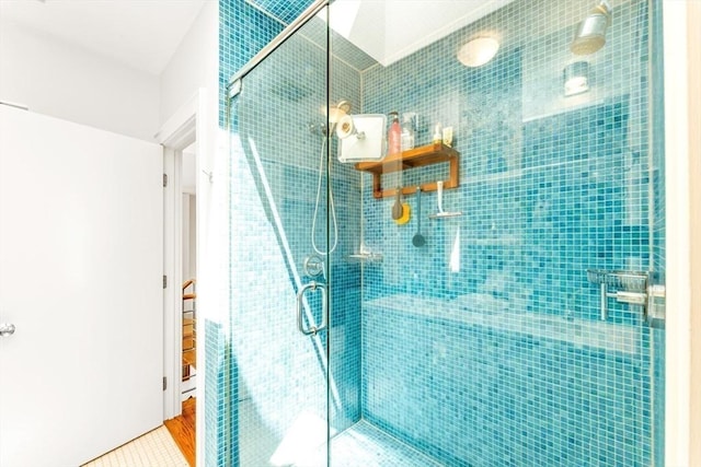 bathroom with a stall shower and tile patterned flooring