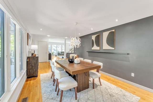 dining area with a chandelier, light wood-style floors, baseboards, and recessed lighting
