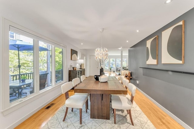 dining space with a chandelier, healthy amount of natural light, light wood finished floors, and recessed lighting
