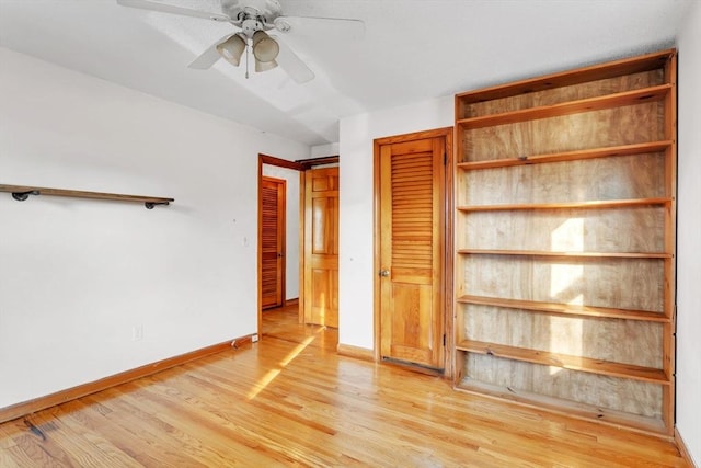 unfurnished bedroom with ceiling fan and light hardwood / wood-style floors